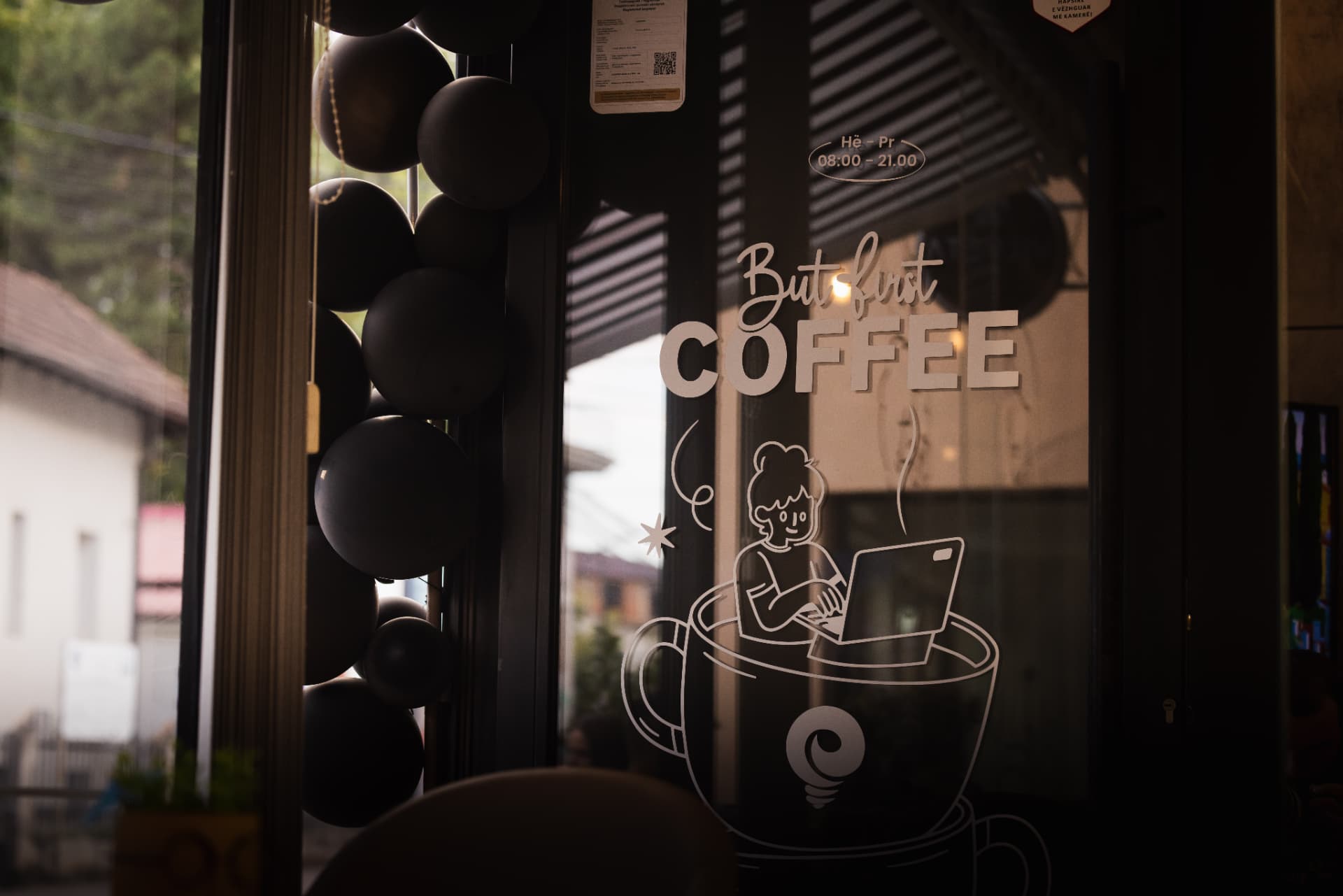 Window decal reading but first coffee at ENO-AD Coffee