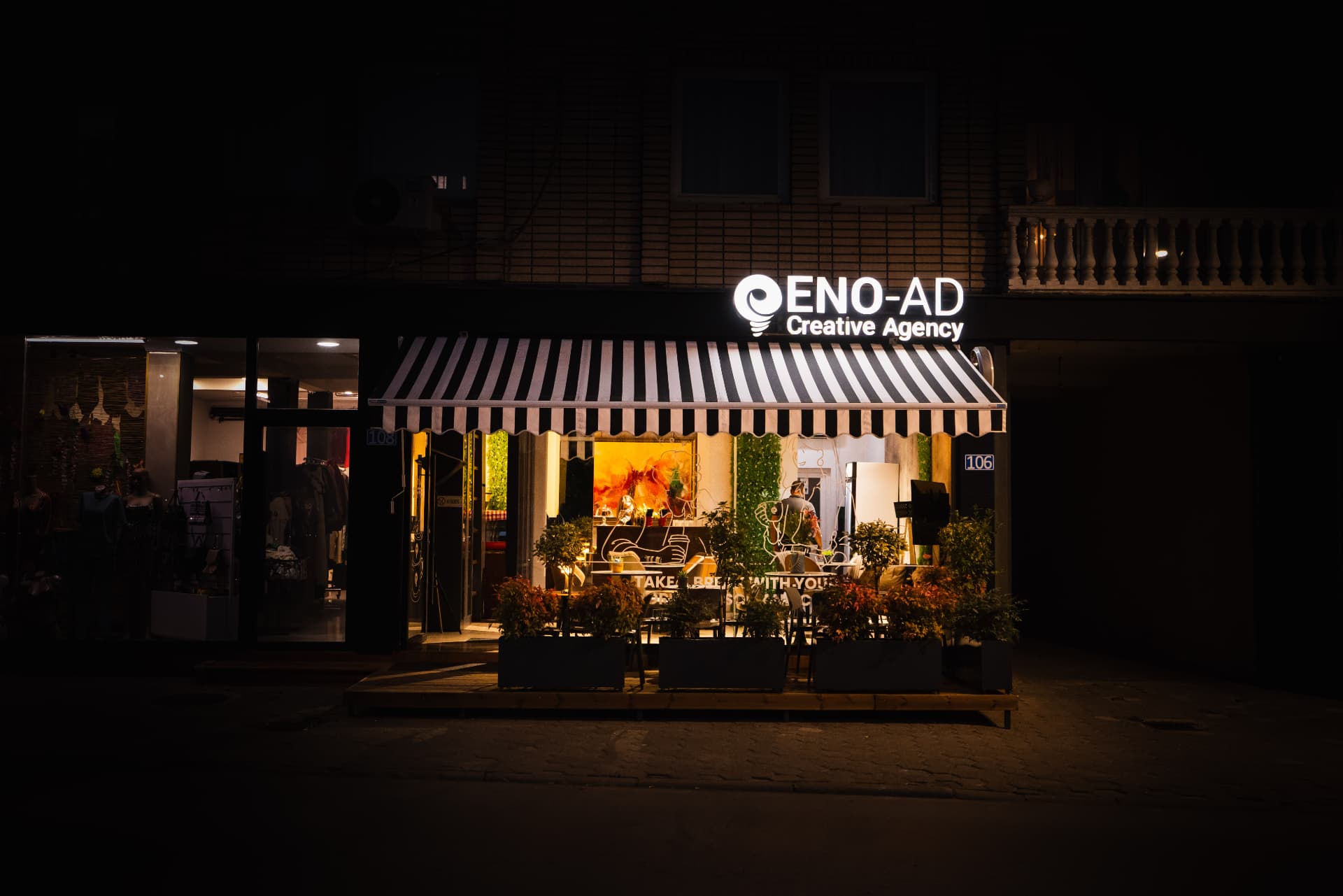 ENO-AD Coffee facade at night with the illuminated sign