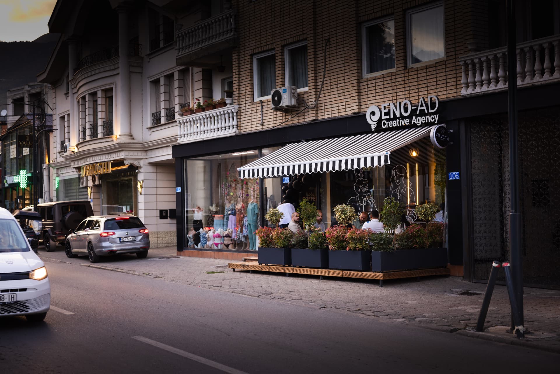 ENO-AD Coffee terrace in golden hour light with outdoor tables