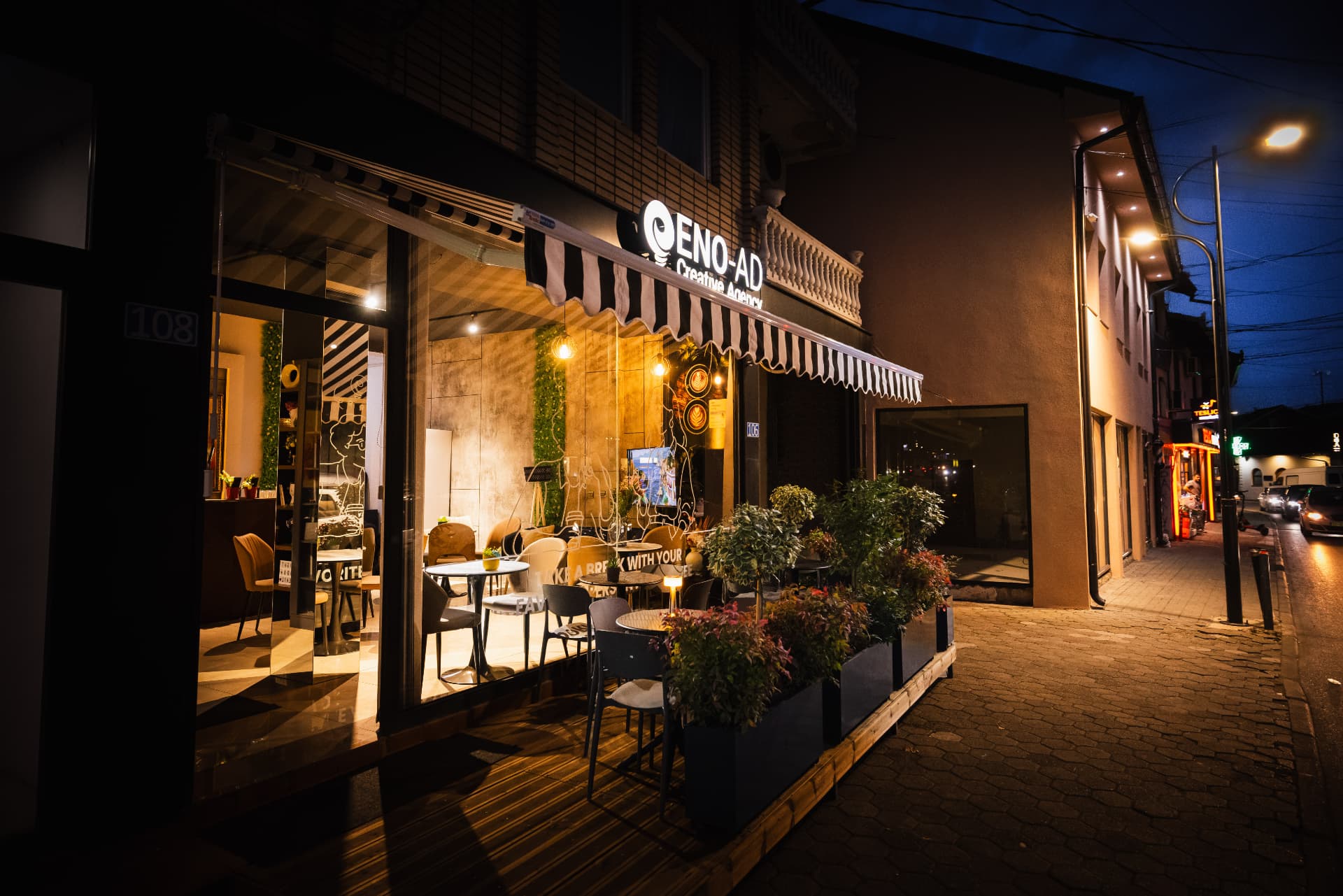 ENO-AD Coffee shopfront at night seen from the street