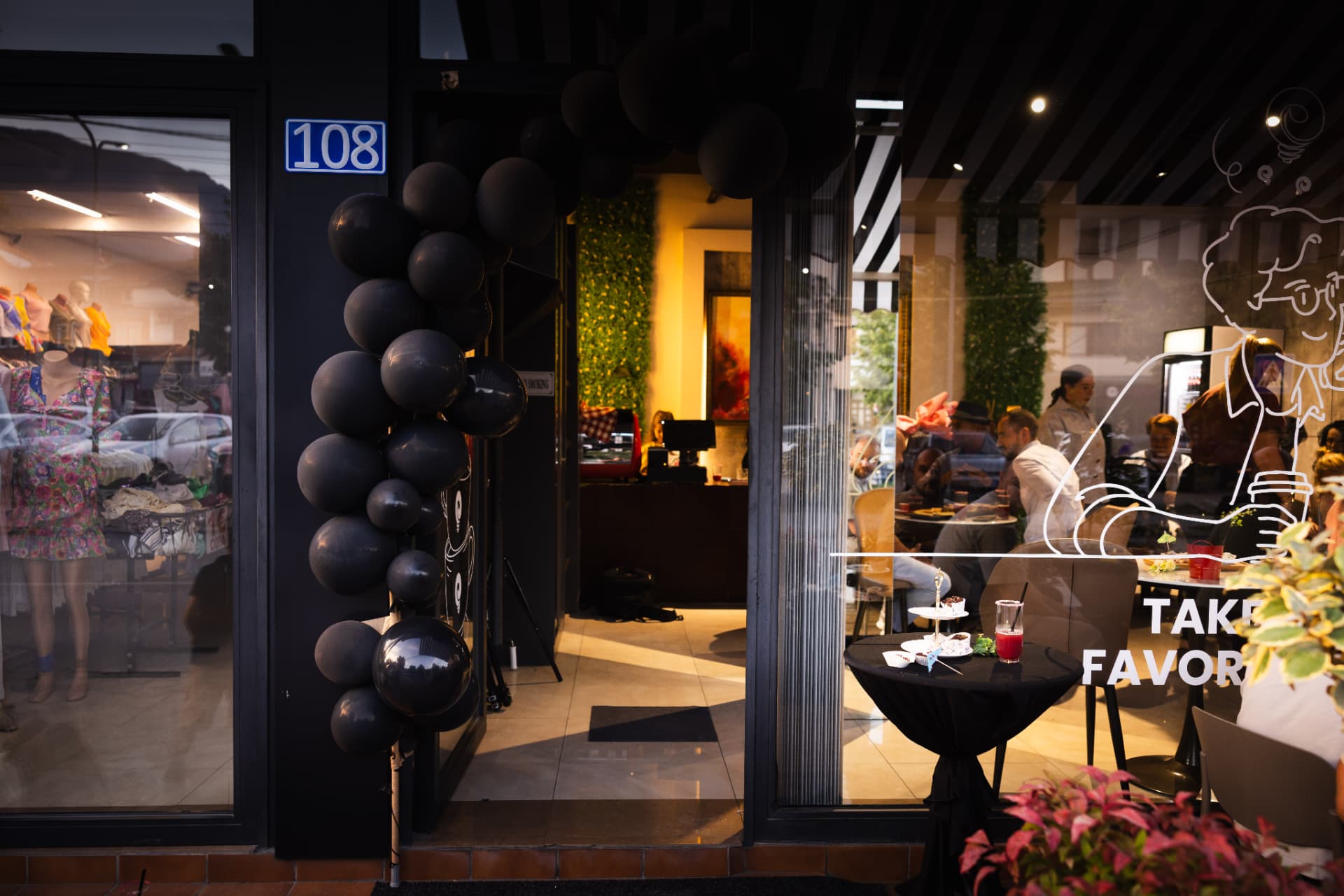 ENO-AD Coffee entrance decorated with a black balloon arch on opening night